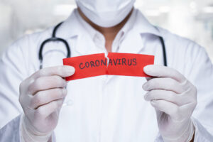 doctor scientist ripping corona virus paper