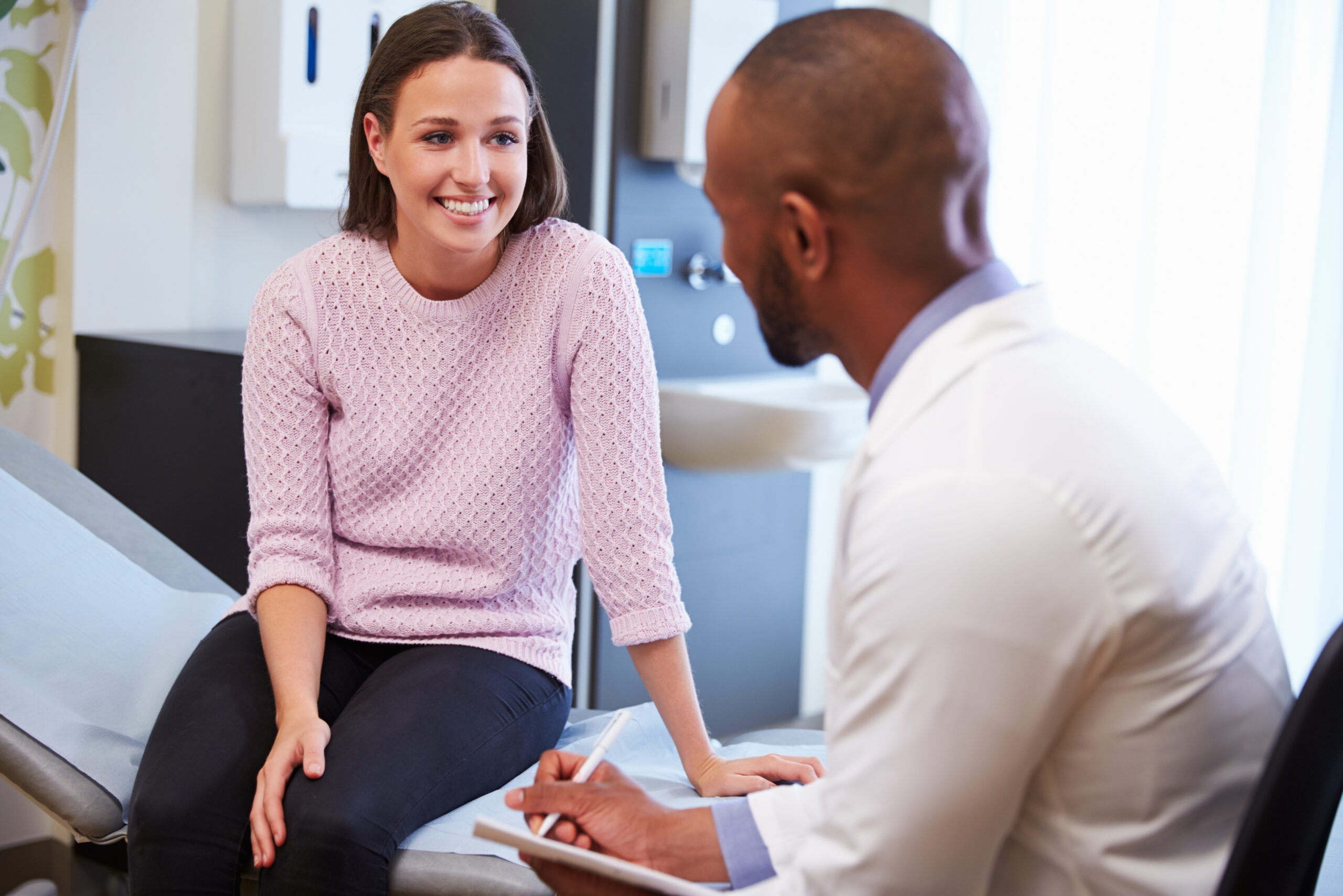 Woman smiling while talking with a doctor